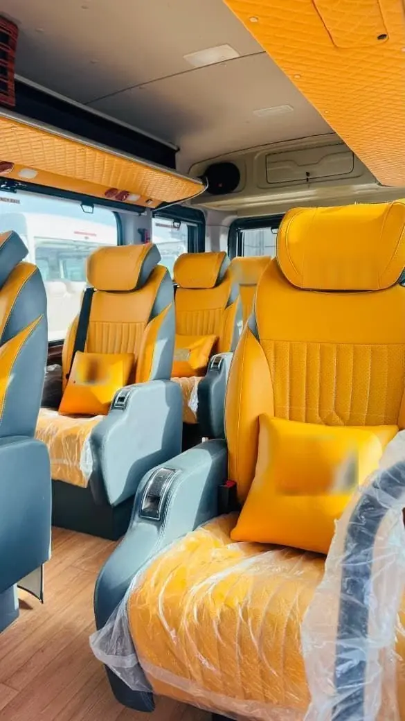 Rows of tan leather recliners inside a Force Urbania Maharaja cabin
